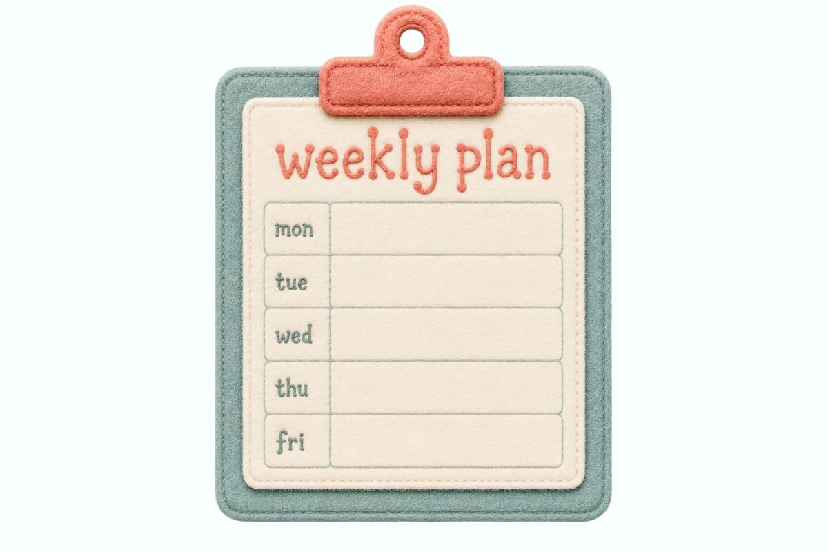 A felt-board clipboard with a blank weekly plan grid on a cream background